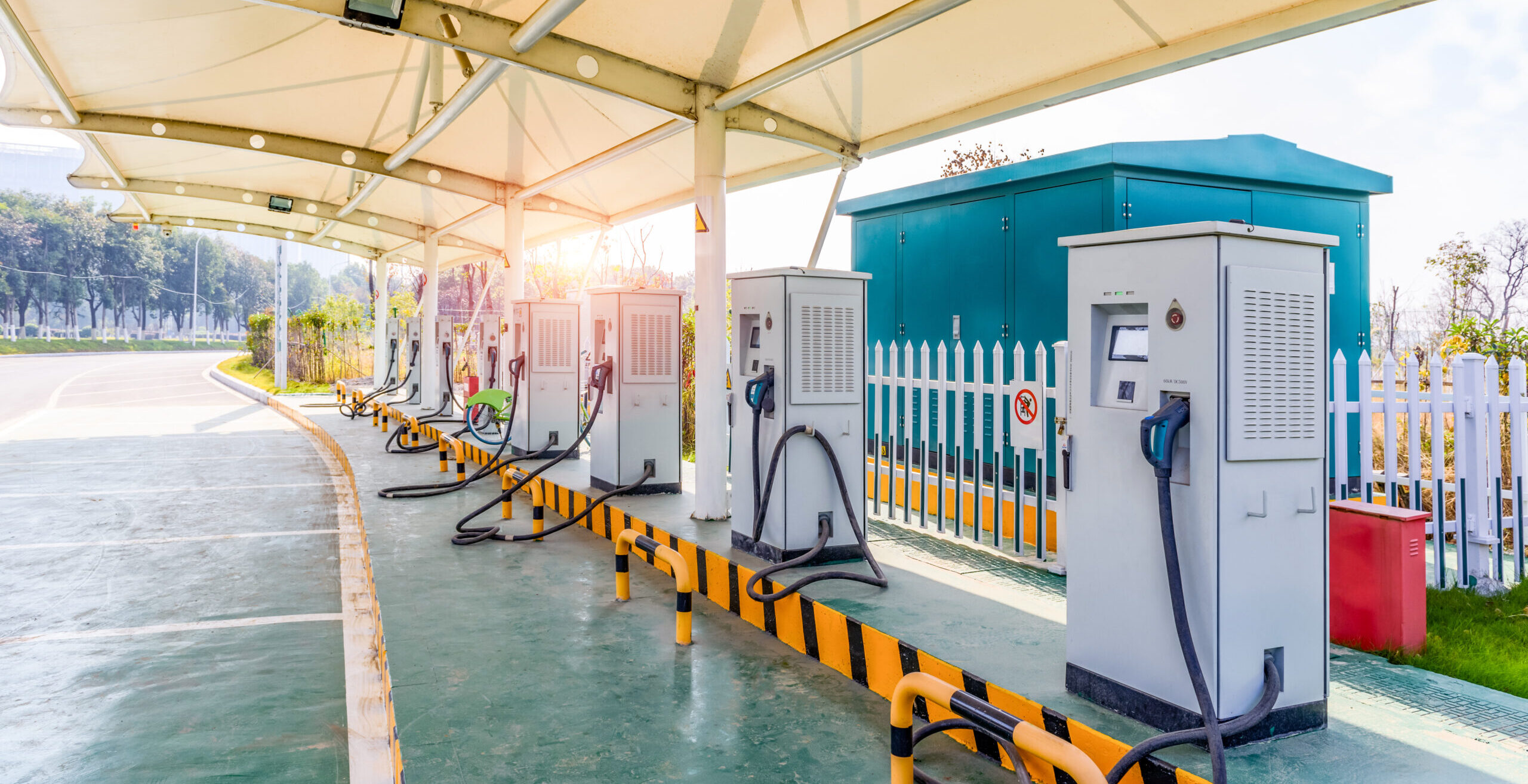 A solar powered electric car charging station in a public parkin A solar powered electric car charging station in a public parkin